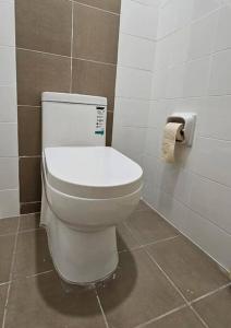 a bathroom with a toilet and a roll of toilet paper at Home at Indera Mahkota Kuantan Unifi 100mb+ TV BOX in Kuantan