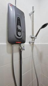 a soap dispenser on the wall of a shower at Home at Indera Mahkota Kuantan Unifi 100mb+ TV BOX in Kuantan