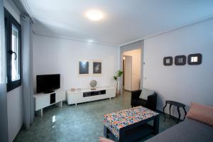 a living room with a couch and a tv at Casa Ángeles in Teruel