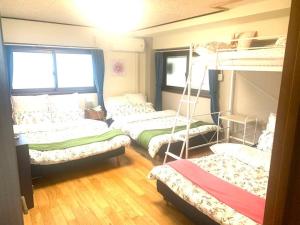 a room with three bunk beds in it at Tokyo KD House 301 in Tokyo