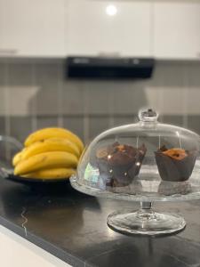 a glass dish with chocolate on a counter with bananas at Grasse - Free Parking - Pool in Grasse