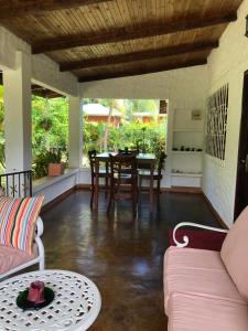 a living room with a table and chairs at HCS Bungalows Turtle Bay Rustic Bungalow in Au Cap