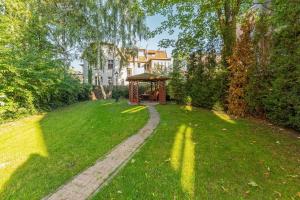 a garden with a gazebo in the grass at Patio Mare - Garden by Grand Apartments in Sopot