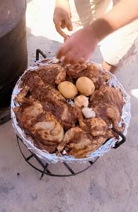 a person is reaching into a basket of food at Madaba Hotel in Madaba