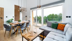a living room with a couch and a table at Hillside, Sun & Snow in Karpacz
