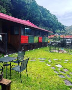 a table and chairs in a yard with a train at Chef's Garden 