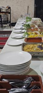 a long table filled with plates and bowls of food at Ammar Rum Camp and tours in Wadi Rum