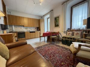 a living room with a couch and a dining room at Appartamenti Casa Albi in Pinzolo