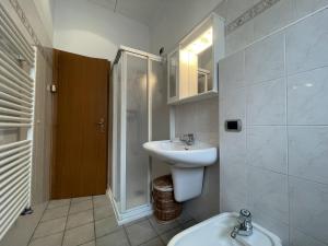 a bathroom with a sink and a shower and a toilet at Appartamenti Casa Albi in Pinzolo +26 photos