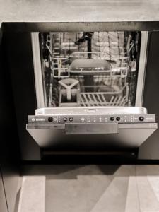 a dishwasher with its door open in a room at CASAGOLD Glyfada Luxury Apartment Near The Sea in Athens