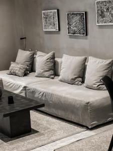a white couch in a living room with a table at CASAGOLD Glyfada Luxury Apartment Near The Sea in Athens