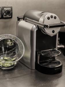 a toaster sitting on a counter next to a bowl of food at CASAGOLD Glyfada Luxury Apartment Near The Sea in Athens