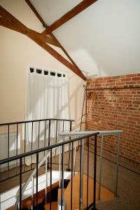 a balcony with a table and a brick wall at Snobs and Rebels Apartments in Shaftesbury