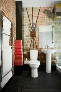 a bathroom with a toilet and a sink at Snobs and Rebels Apartments in Shaftesbury