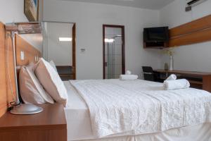 Ein Bett oder Betten in einem Zimmer der Unterkunft Inácios Hotel ltda