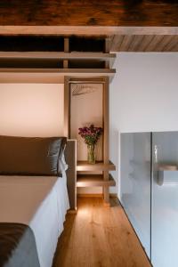 a bedroom with a bed and a vase of flowers at Palazzo Garibaldi - Boutique Suites in Barletta +54 photos