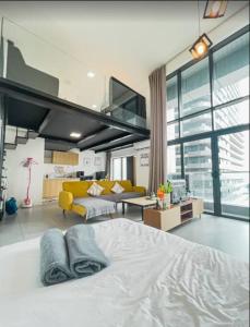 a bedroom with a large bed and a yellow couch at Spacious City Duplex 2 to 6pax, 1U-Ikea-Curve, Netflix in Petaling Jaya