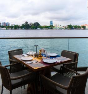 a table with chairs and a view of the water at Maroko Bayshore Suites in Lagos