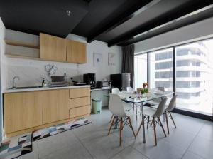 a kitchen with a table and chairs in a room at Spacious City Duplex 2 to 6pax, 1U-Ikea-Curve, Netflix in Petaling Jaya