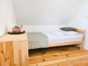 a bed in a room with a wooden table at Sunset Kaszuby in Chrztowo