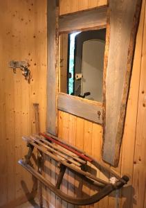 a mirror in a wooden room with a bench at HARZchen in Sankt Andreasberg