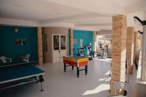 a room with a ping pong table and ping pong balls at Halykos Hotel in Cammarata