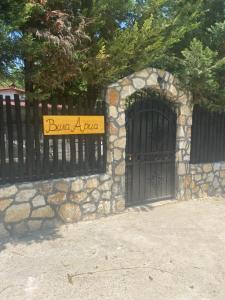 a gate with a sign in front of a fence at Vila Aria 