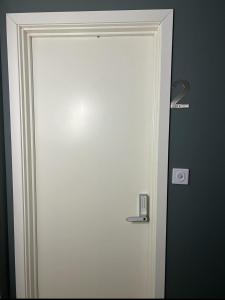a white door with a mirror in a room at Vadlåsveien 4 in Egersund +2 photos