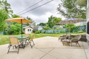 a patio with tables and chairs and umbrellas at Glen Ellyn Home Walk to Downtown Dining and Shops! in Glen Ellyn