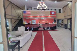a lobby with a red carpet and an american flag at Ramada by Wyndham Mountain Home in Mountain Home