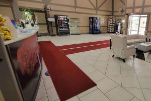 a store lobby with a red stripe on the floor at Ramada by Wyndham Mountain Home in Mountain Home