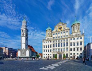 a large white building with a clock tower on it at Augsburg Hotelturm in Augsburg