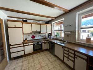 a kitchen with white cabinets and a sink at Bodos-Auszeit in Weitnau