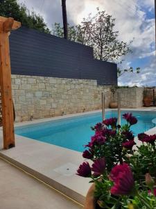 a swimming pool with a bunch of flowers next to it at Hammam, Private Pool & Home Cinema - Green Sight in Prasás