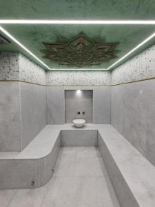 a bathroom with a sink in the middle of a room at Hammam, Private Pool & Home Cinema - Green Sight in Prasás
