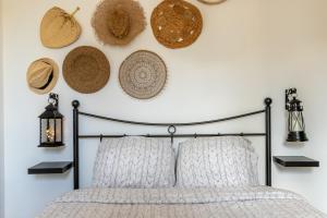 a bedroom with a bed with hats on the wall at La maisonnette bien-être in Bagneux