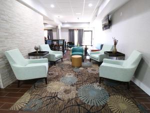 a waiting room with couches and chairs on a rug at Hampton Inn Saint Augustine-I-95 in St. Augustine