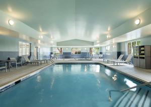 a large pool with blue water in a building at Homewood Suites by Hilton Somerset in Somerset