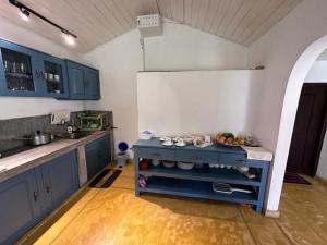 a kitchen with blue cabinets and a white refrigerator at Fantasea in Mirissa