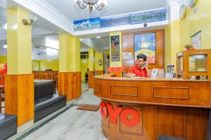 a man standing at a counter in a restaurant at OYO 807 Hotel Grand Tokyo in Kathmandu