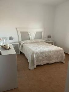 a bedroom with a bed with two tables and two lamps at Casa Rural La Costa in La Lapa +50 photos
