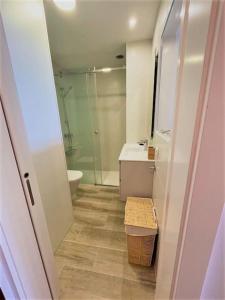 a bathroom with a shower and a toilet and a sink at Holidays in My Barra Canteras in Las Palmas de Gran Canaria +12 photos