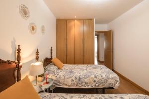 A bed or beds in a room at La Minilla Suite