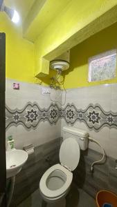 a bathroom with a toilet and a sink at Destination of peace kasol in Kasol