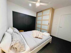 a bedroom with a large bed with a black headboard at Lightsview Entire Apt 9 KM from CBD in Broadview