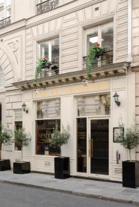 a store front of a building with potted plants at Meli&aacute; Paris Vend&ocirc;me in Paris