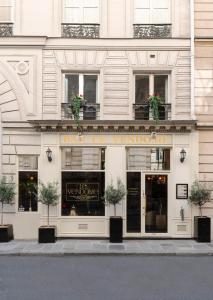 a store front of a building with potted plants at Meli&aacute; Paris Vend&ocirc;me in Paris