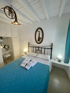 a bedroom with a bed with two towels on it at Mykonos Secret Spot in Mýkonos City