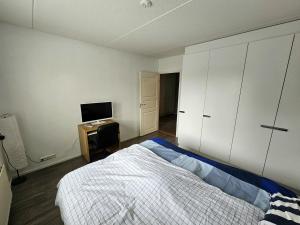sypialnia z łóżkiem i telewizorem w obiekcie Tilava kaksio, saunalla ja sähköauton latauksella. w mieście Tampere
