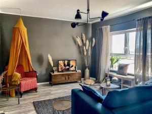 a living room with a blue couch and a table at Olivia in Tholey